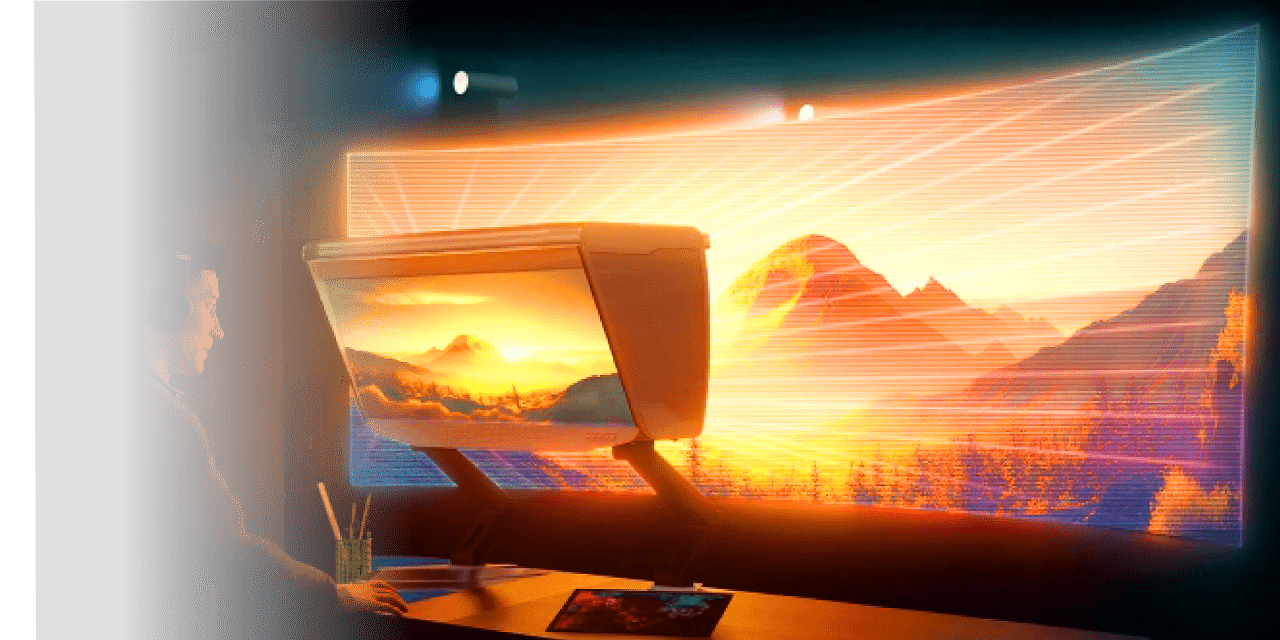 Person seated at a desk using a curved monitor projecting a sunset over mountains on a large wall display.